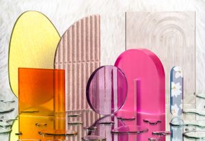 Colorful glass arches in yellow, orange, pink and purple creating abstract geometric composition.