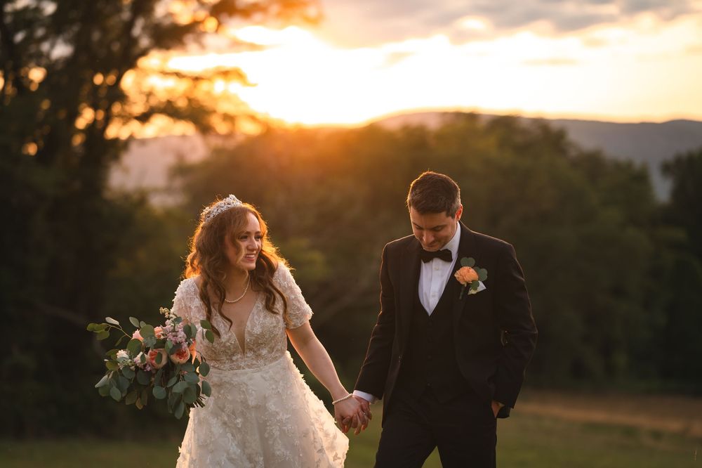 Newlyweds share tender moments during golden hour sunset photography session in scenic outdoor setting of The Garrison in Garrison, NY.