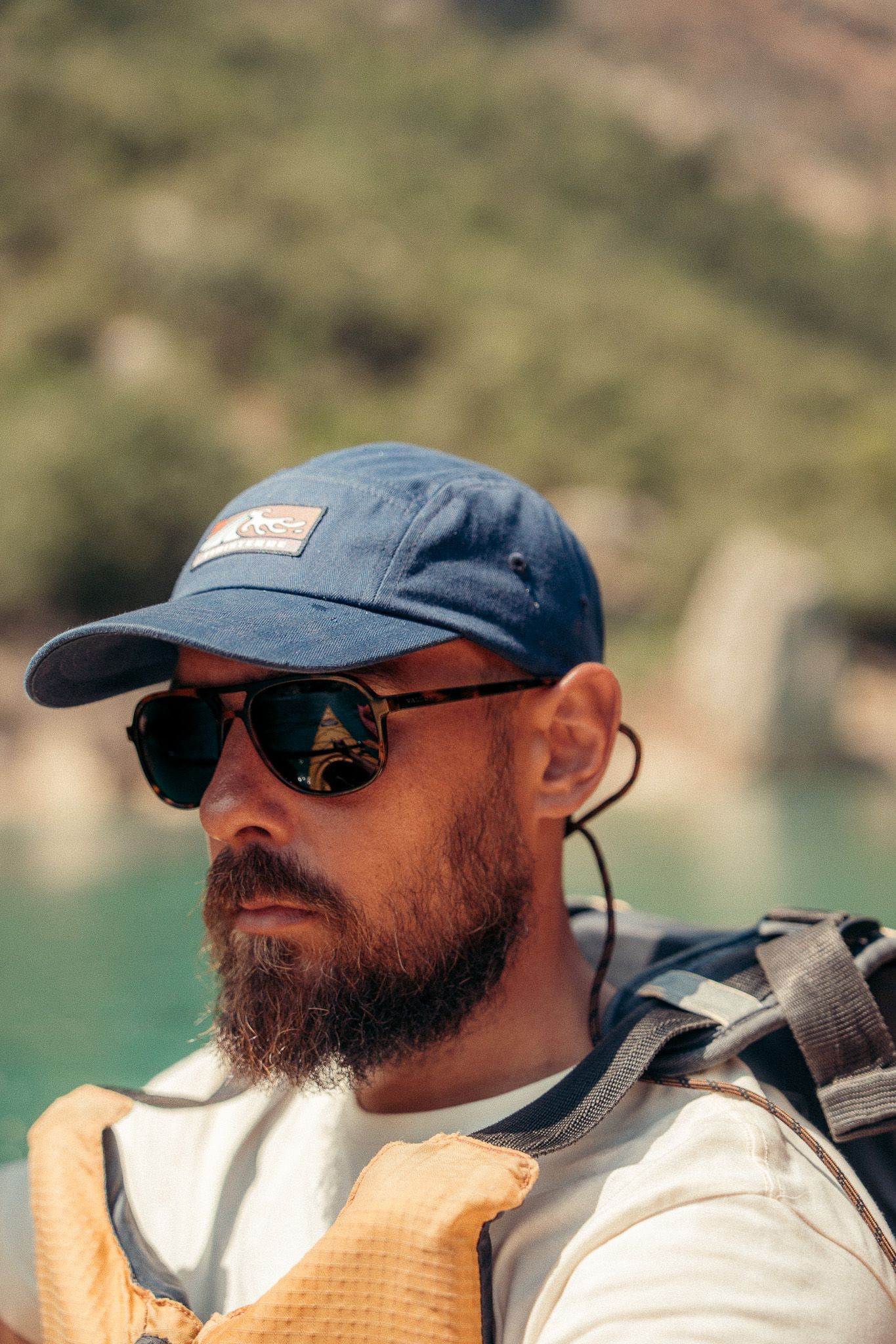 A kayaker enjoying a peaceful moment on turquoise waters surrounded by canyon walls.
