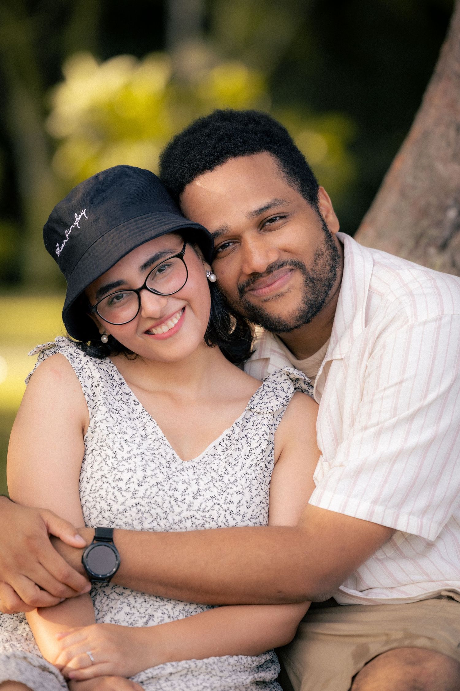 A couple shares intimate moments outdoors in a series of romantic portrait photos wearing white and black outfits.