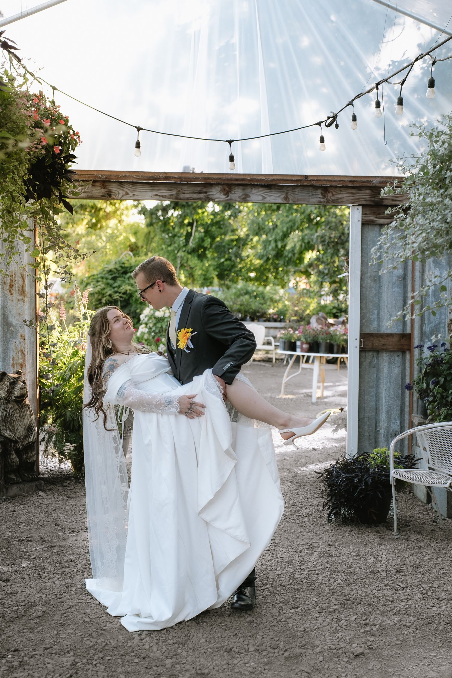 A romantic wedding scene under string lights and a white tent.
