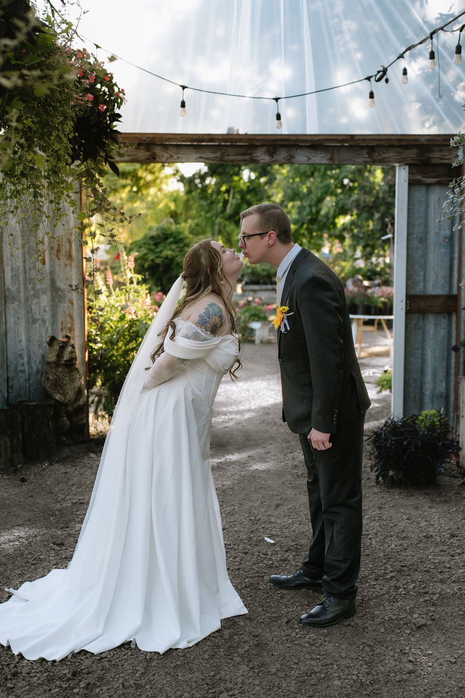 A couple shares intimate moments during their outdoor wedding celebration.