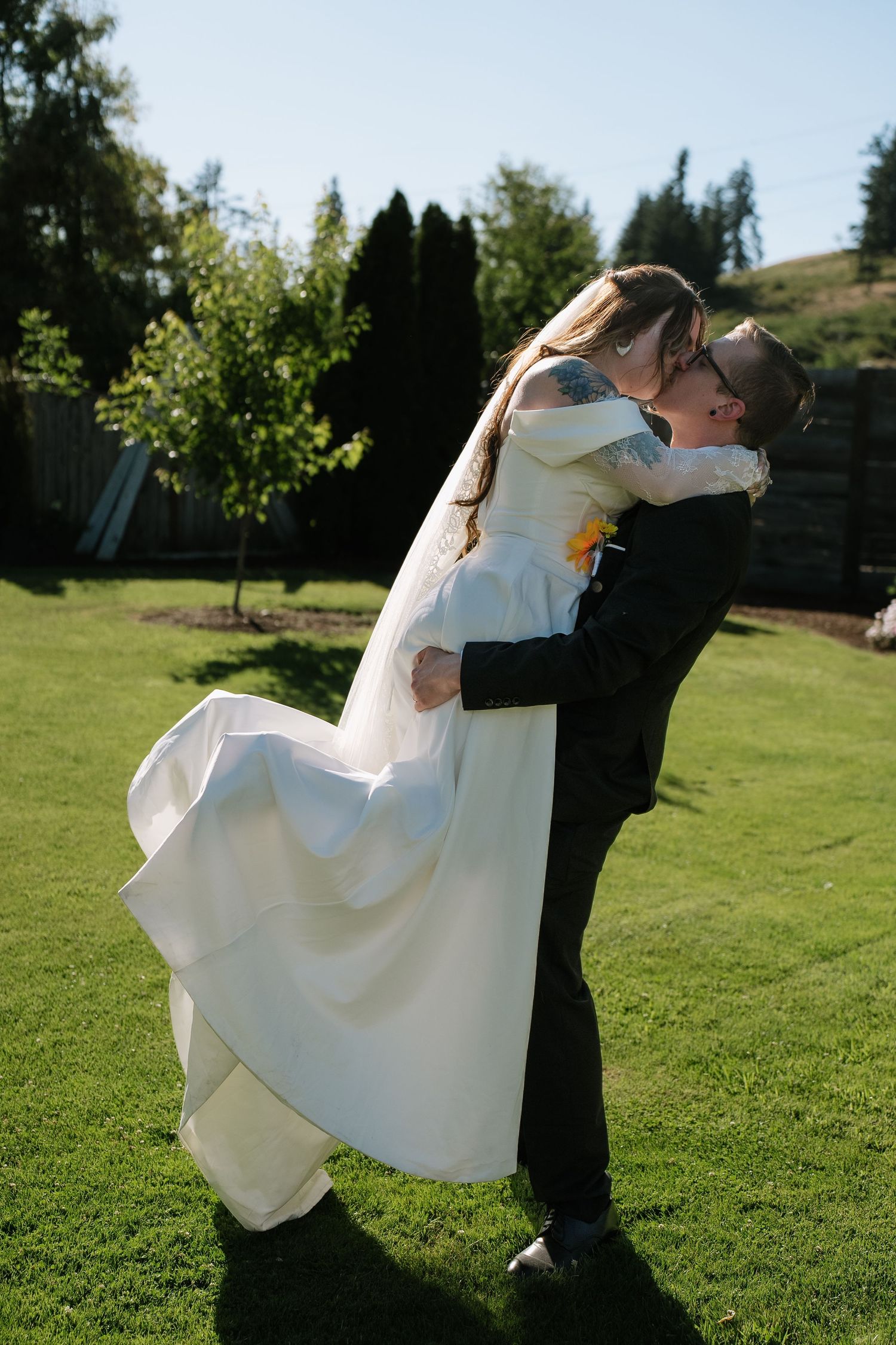 A joyful wedding dance captured in golden afternoon sunlight.