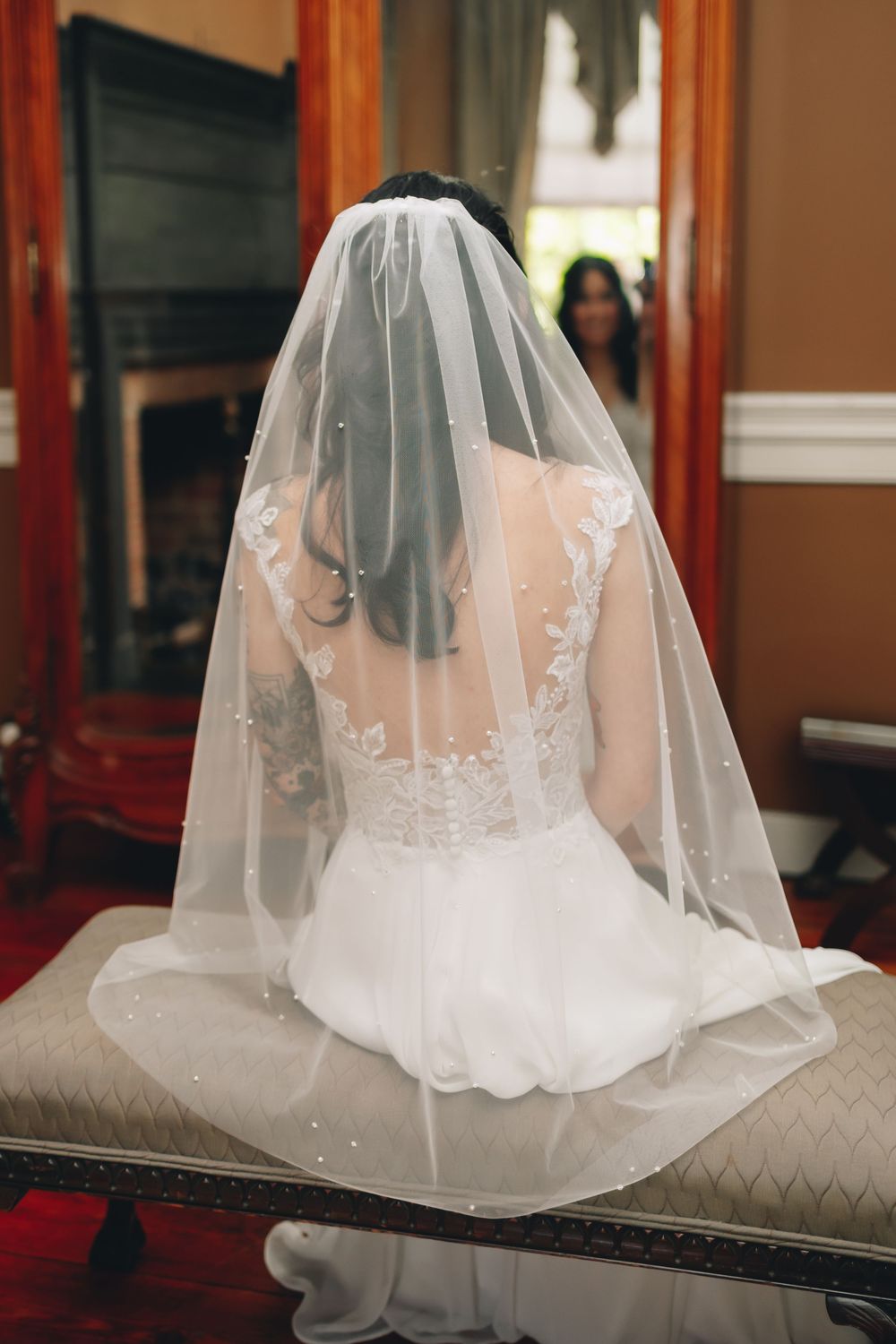 Multiple close-up shots of a delicate white wedding veil with lace details resting on a couch.