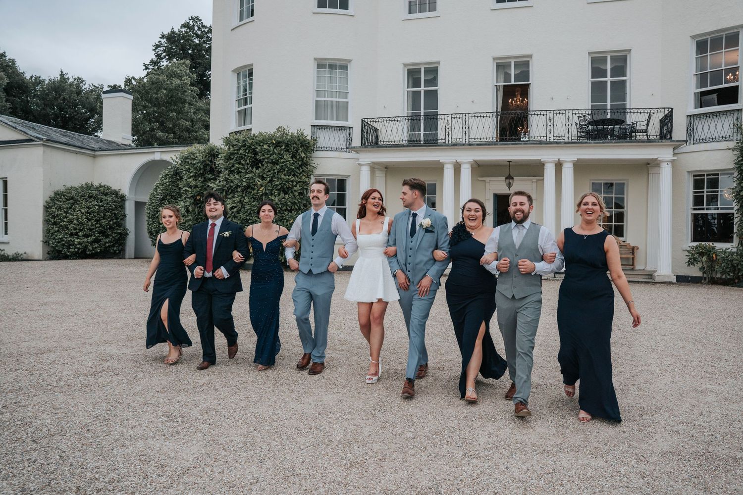 Group portraits with bridal party in front of Rockbeare Manor entrance