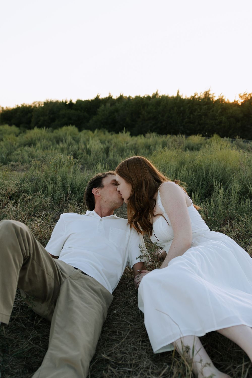 Intimate black and white photos capture tender moments between a couple in nature.