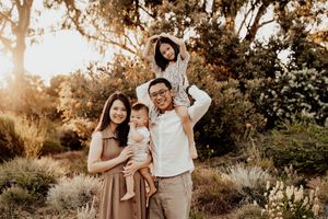 Beautiful golden hour family photography session with natural lighting and outdoor setting.