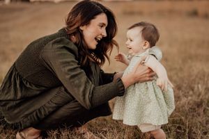Sweet candid moments between mother and child during outdoor portrait session.