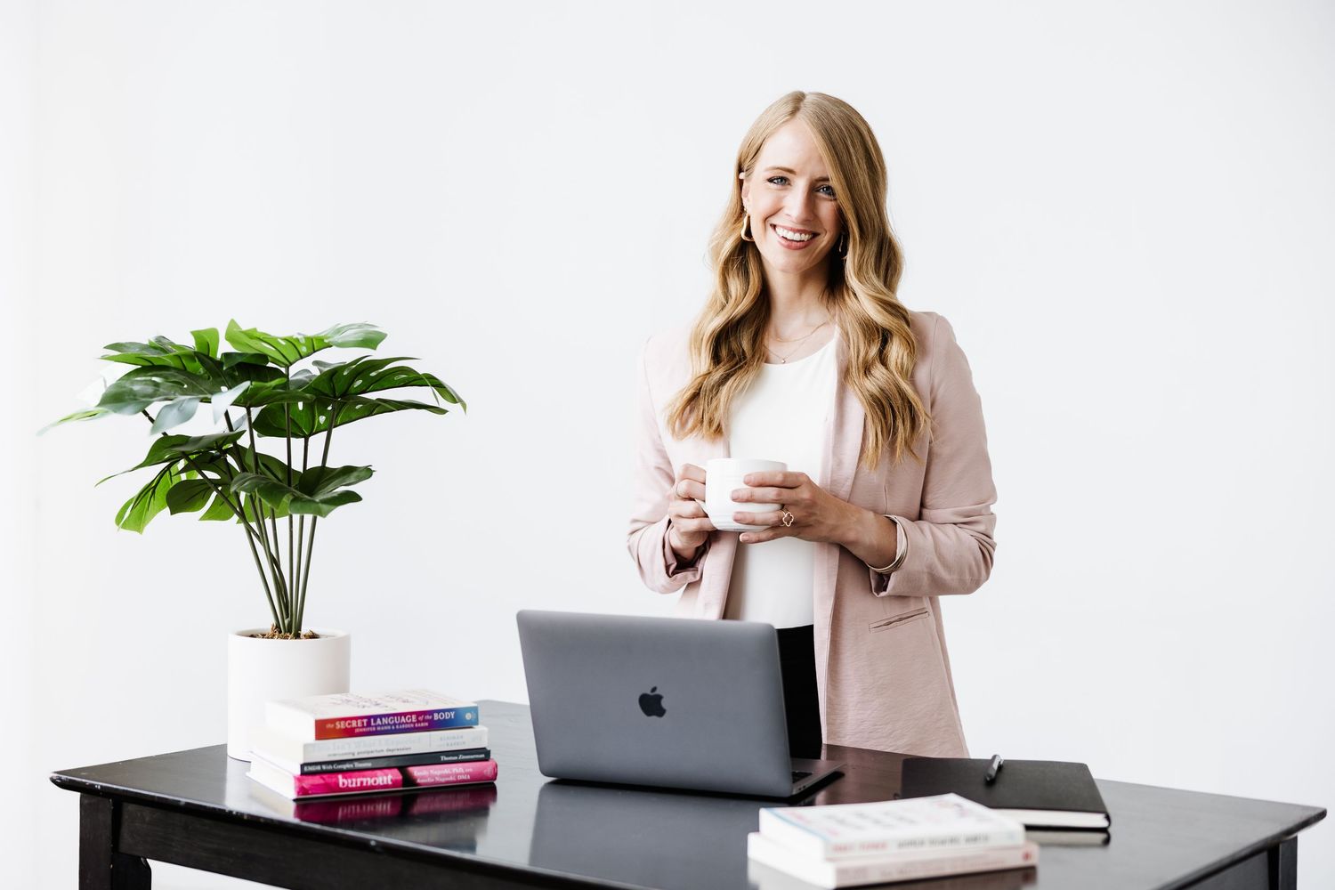 Commercial Lifestyle Branding | Dayton Photographer | Modern workspace setup with laptop, plants and pink accessories on white desk.