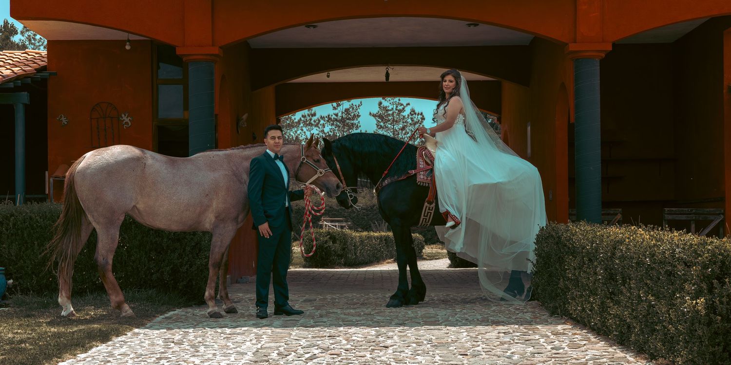 A panoramic view of a wedding venue with stone archways and outdoor seating arrangements.
