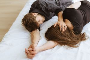 Intimate couple lying down together sharing quiet moment of connection.