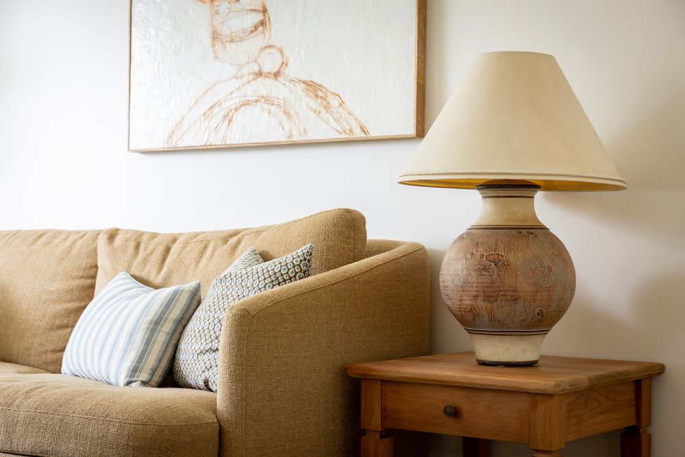 brown sofa and pottery lamp
