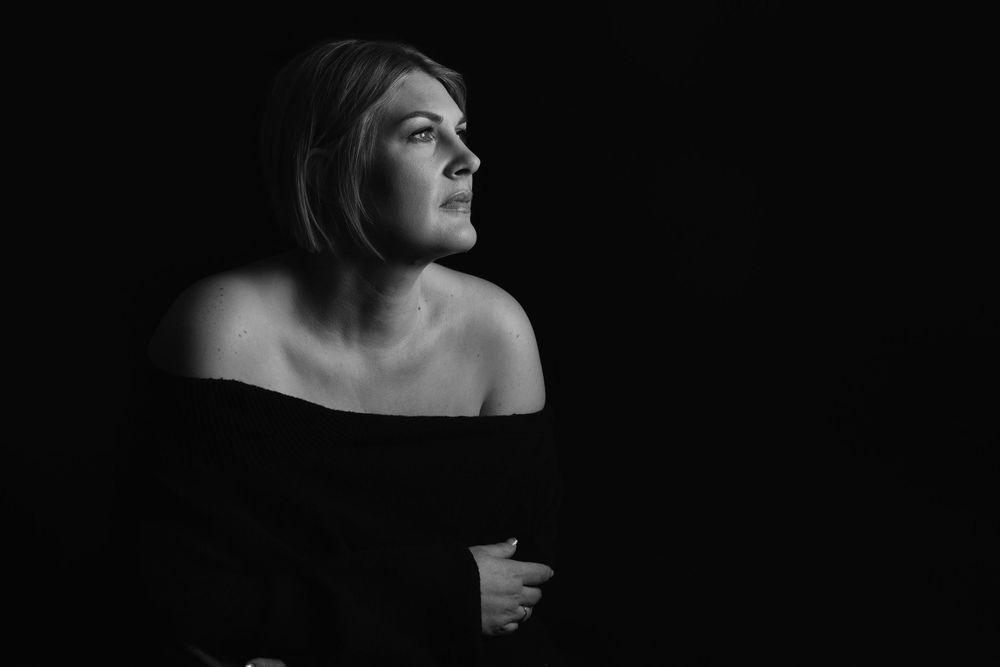 Black and white artistic portrait series showing dramatic side profiles and expressions in dark lighting.