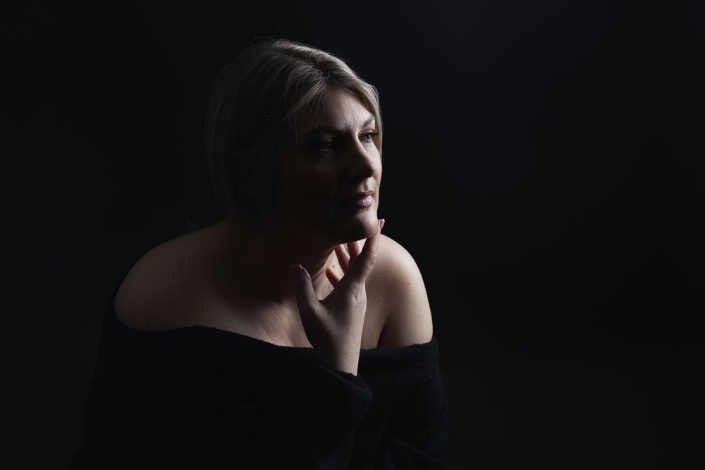 Dramatic black and white portrait series showing a person's profile against a dark background.