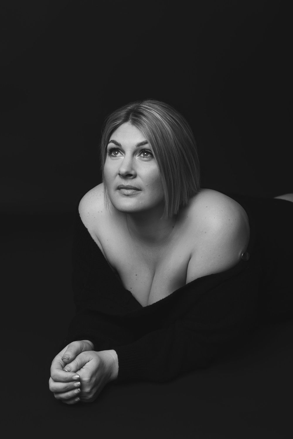 Dramatic black and white portrait series showing close-up views of a person's face and shoulders against dark background.