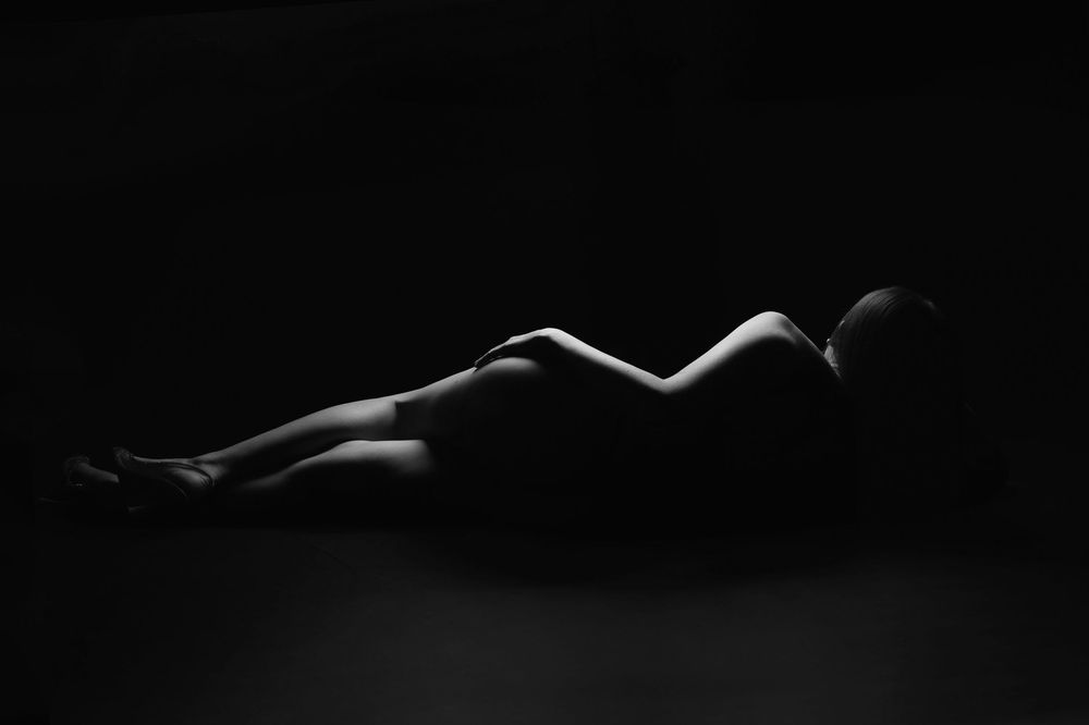 Black and white artistic nude photography series showing silhouettes of the human form against dark backgrounds.