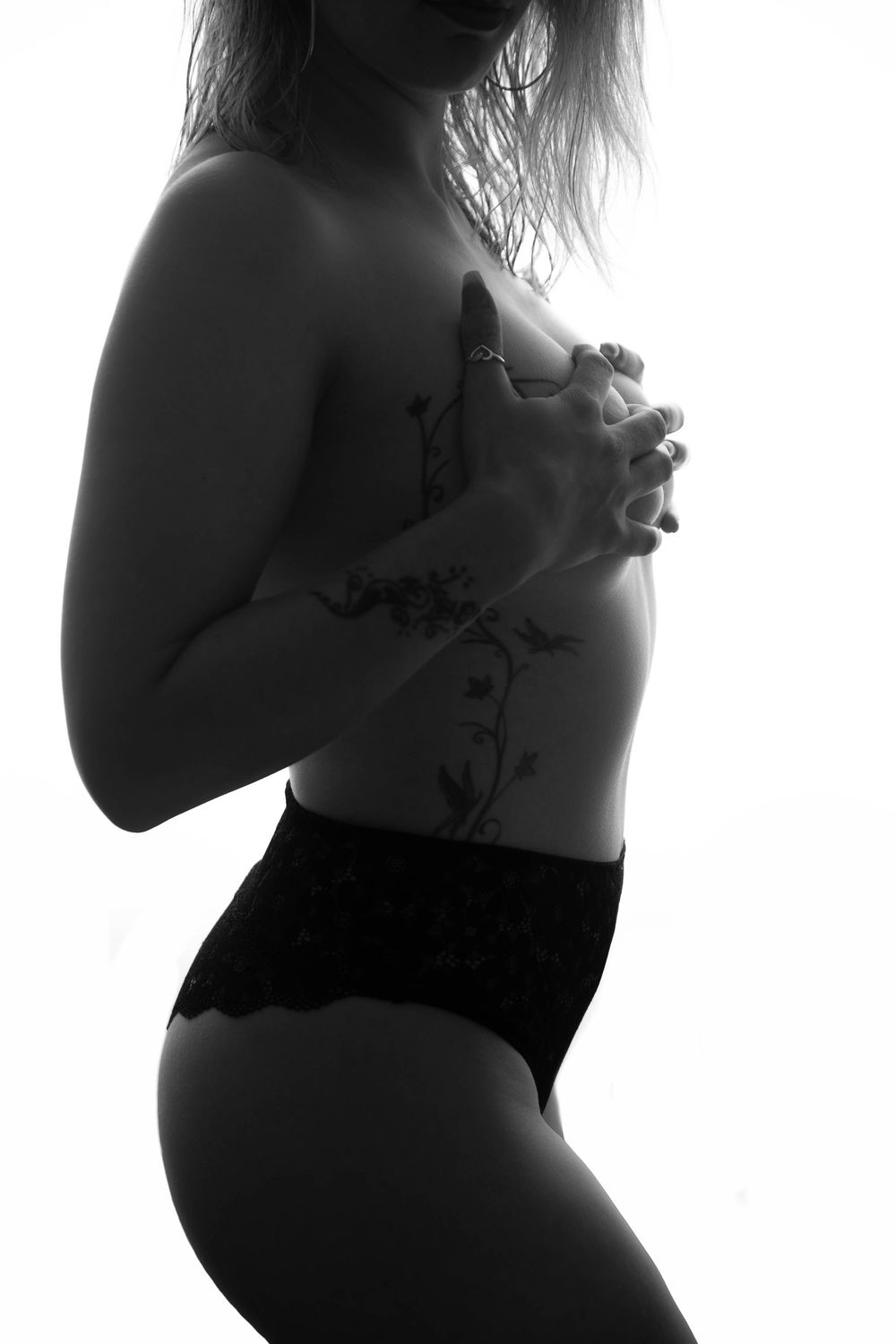 Black and white artistic maternity silhouettes showing pregnancy progression in side profile poses.