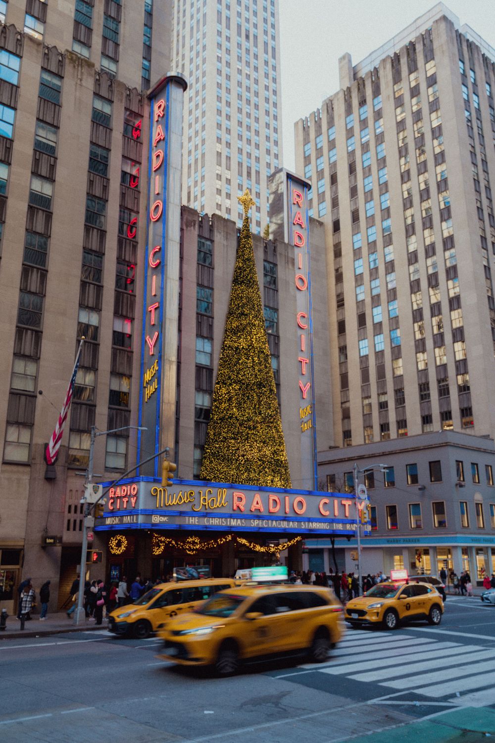 Radio city and yellow taxi, in New York City.