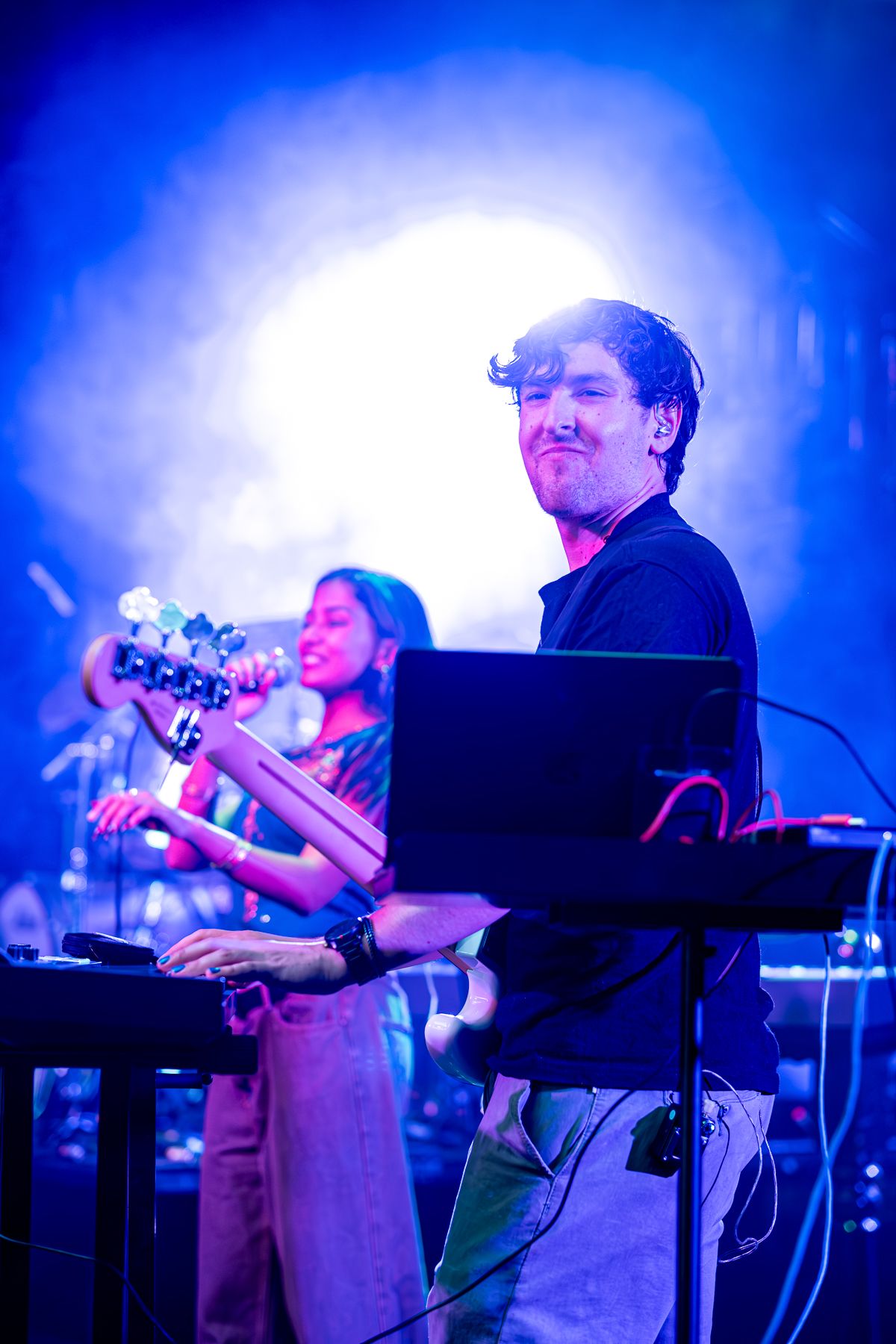 Band performs on stage with dramatic blue lighting during evening concert taken by Melbourne concert and event photographer.