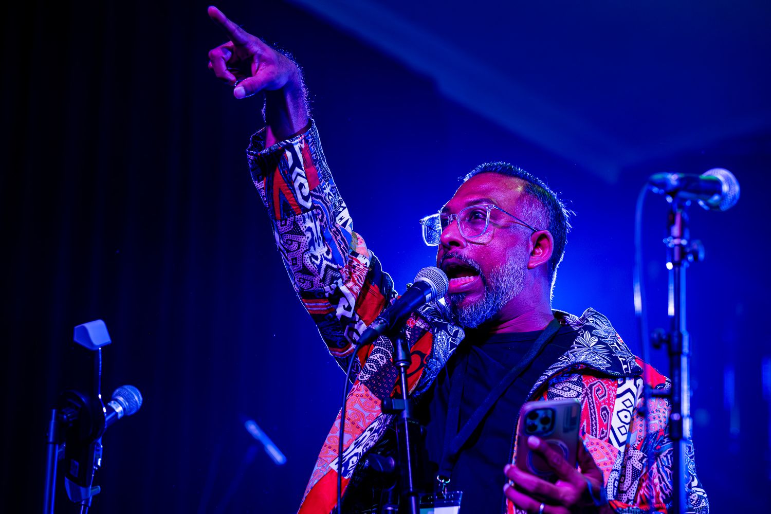 Band performs on stage with dramatic blue lighting during evening concert taken by Melbourne concert and event photographer.