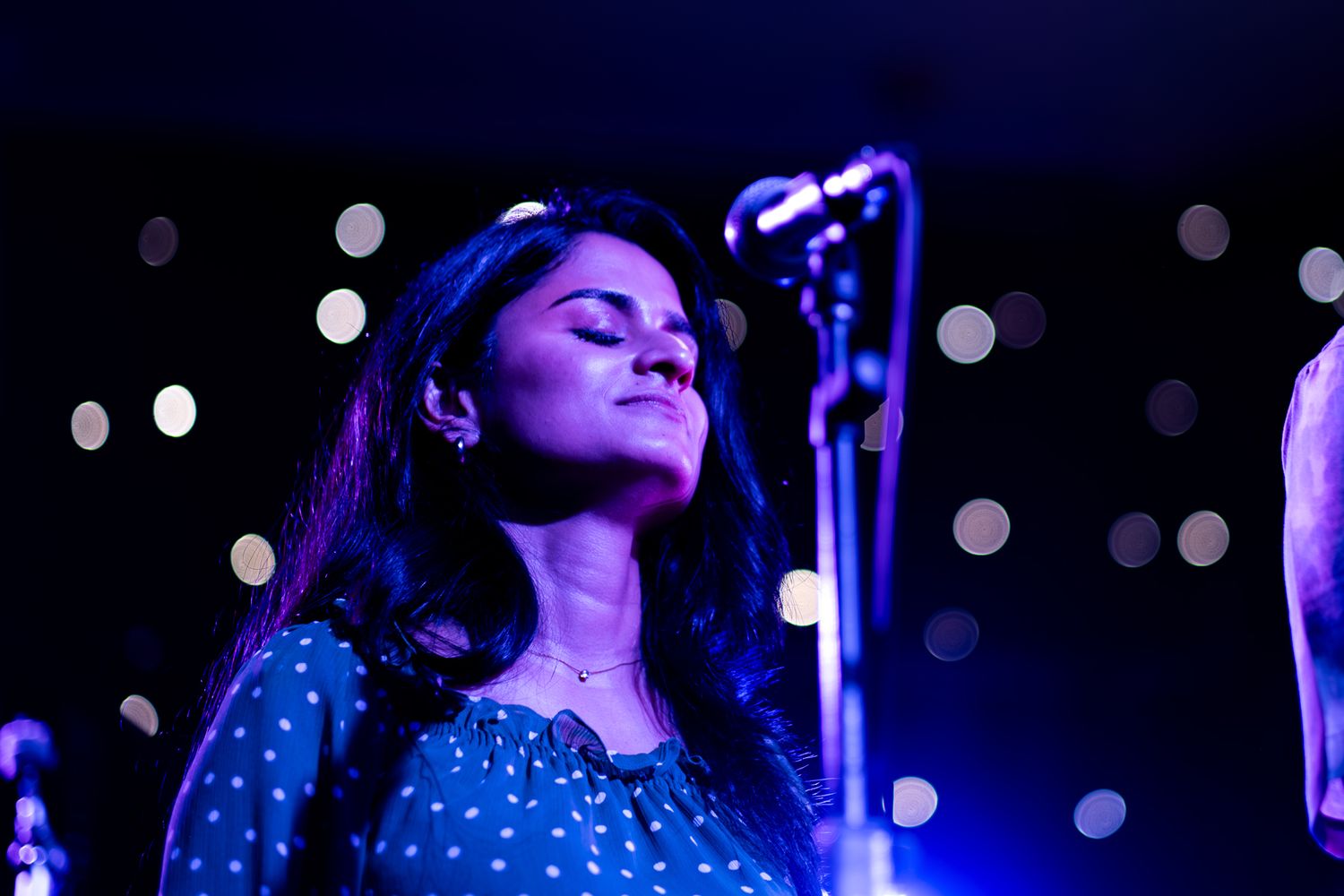 Band performs on stage with dramatic blue lighting during evening concert taken by Melbourne concert and event photographer.