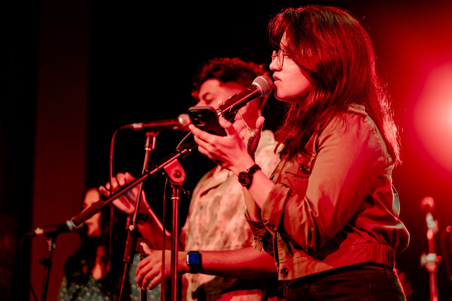 Band performs on stage with colorful rainbow lighting during evening concert taken by Melbourne concert and event photographer.