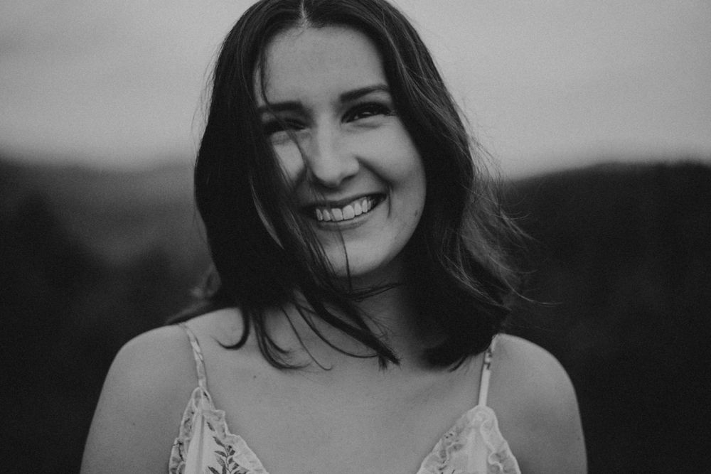 Black and white candid portrait showcasing natural joy and laughter.