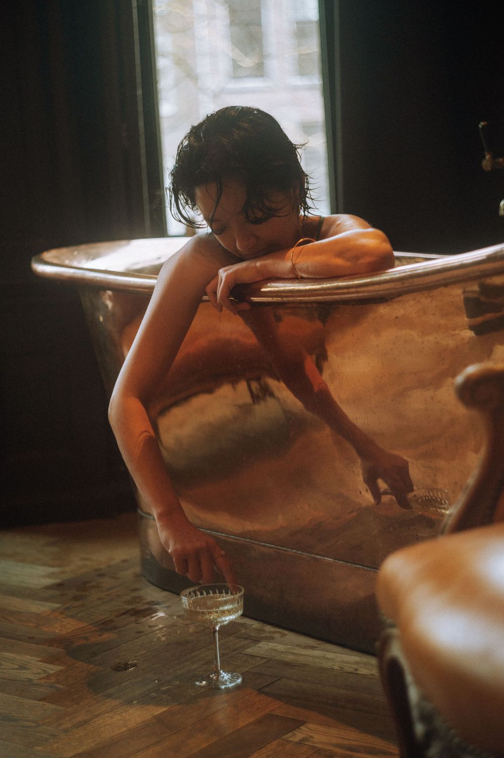 Artistic series of dark moody photos showing a bathtub scene with dramatic lighting and shadows.