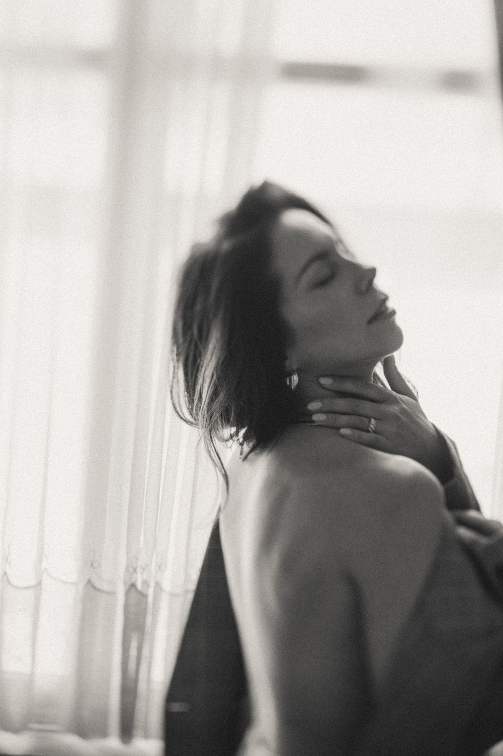High key portrait series with flowing movement against white curtained window.
