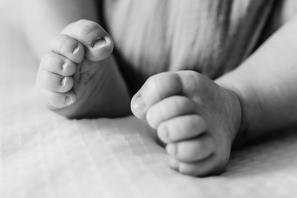 Black and white macro photography of newborn baby toes.