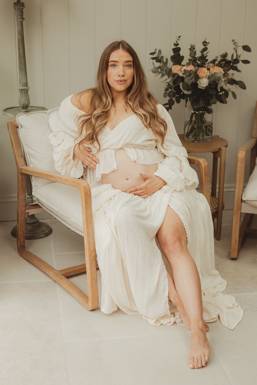 Ethereal maternity portraits in a white dress against neutral backgrounds.