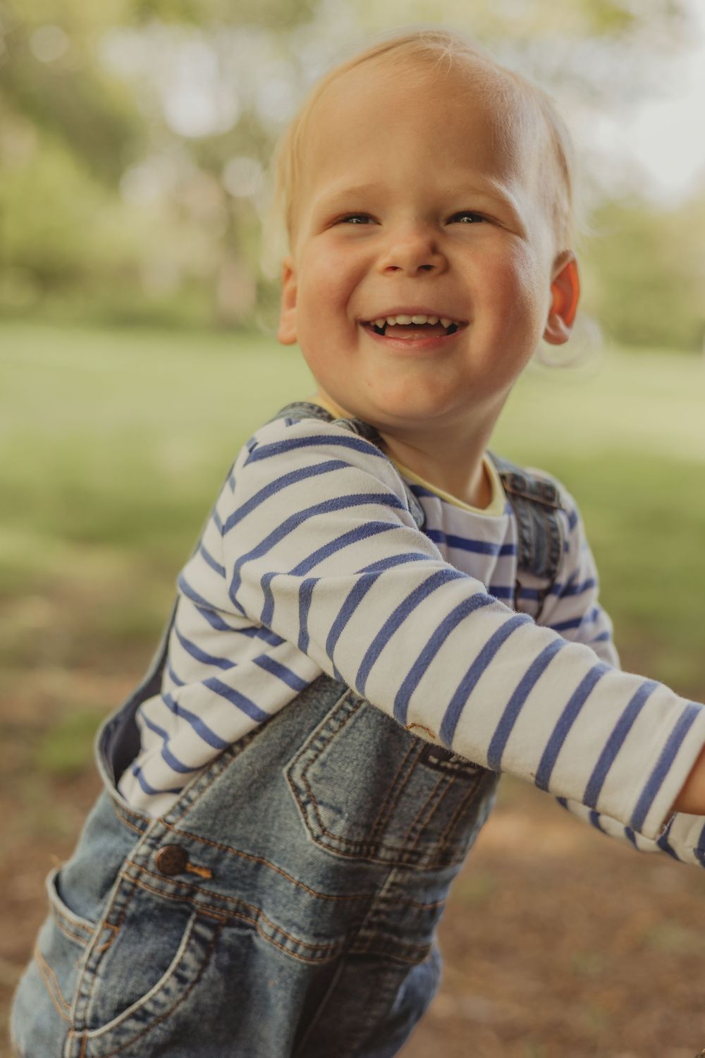 toddler boy laughing outside on Wandsworth common