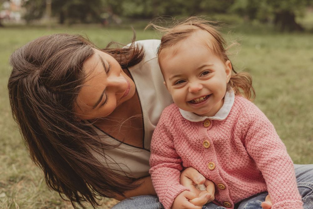 mum and toddler laughing outside on tooting common