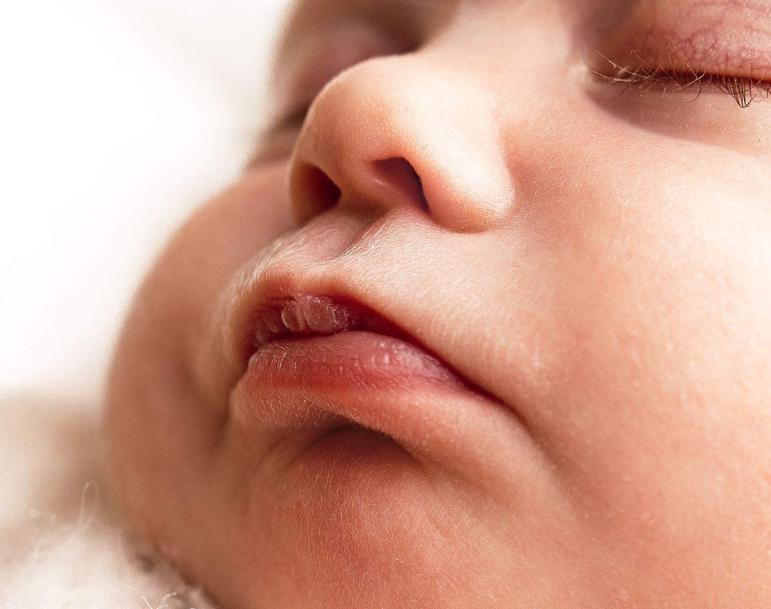 Harrisonburg photographer, newborn, family, maternity photography, detail shot of baby girl's long eyelashes and pink lips.
