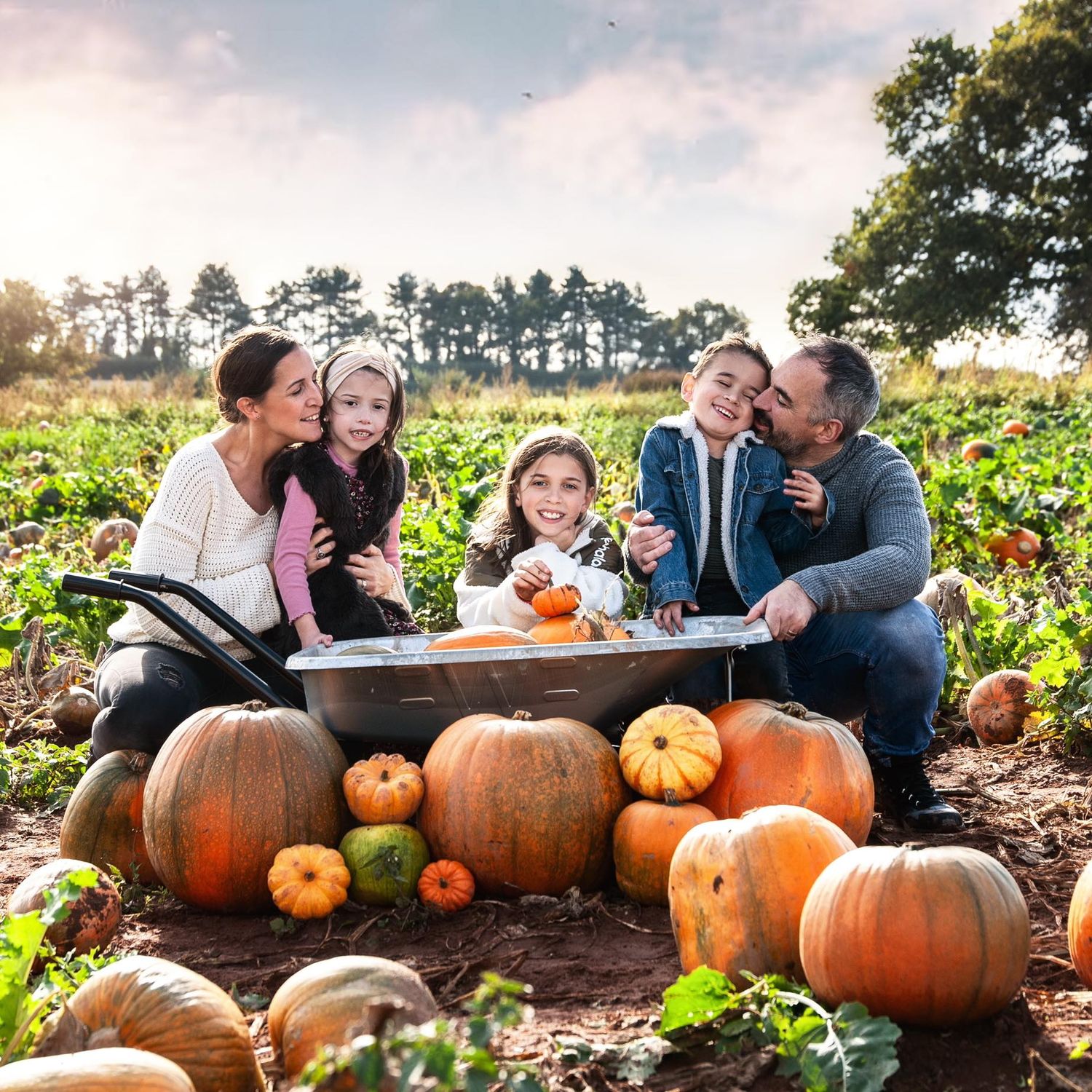 family photo in pumpkin field by kara jade photography
