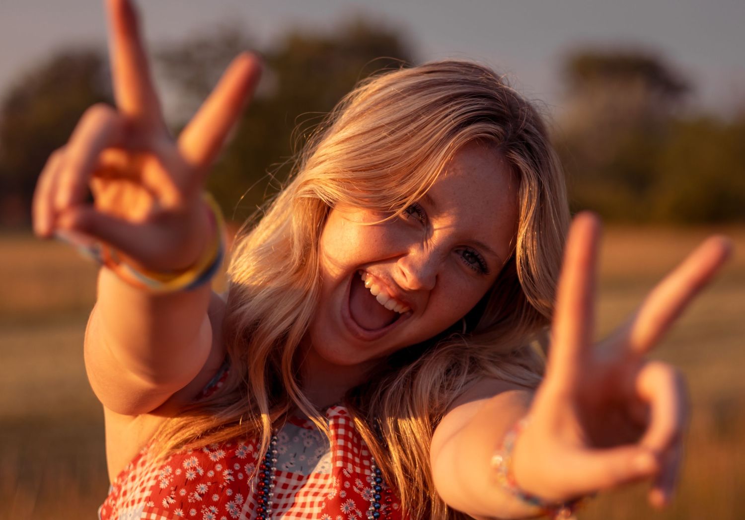 Candid sunset portraits showing joyful expressions and gestures in warm lighting.