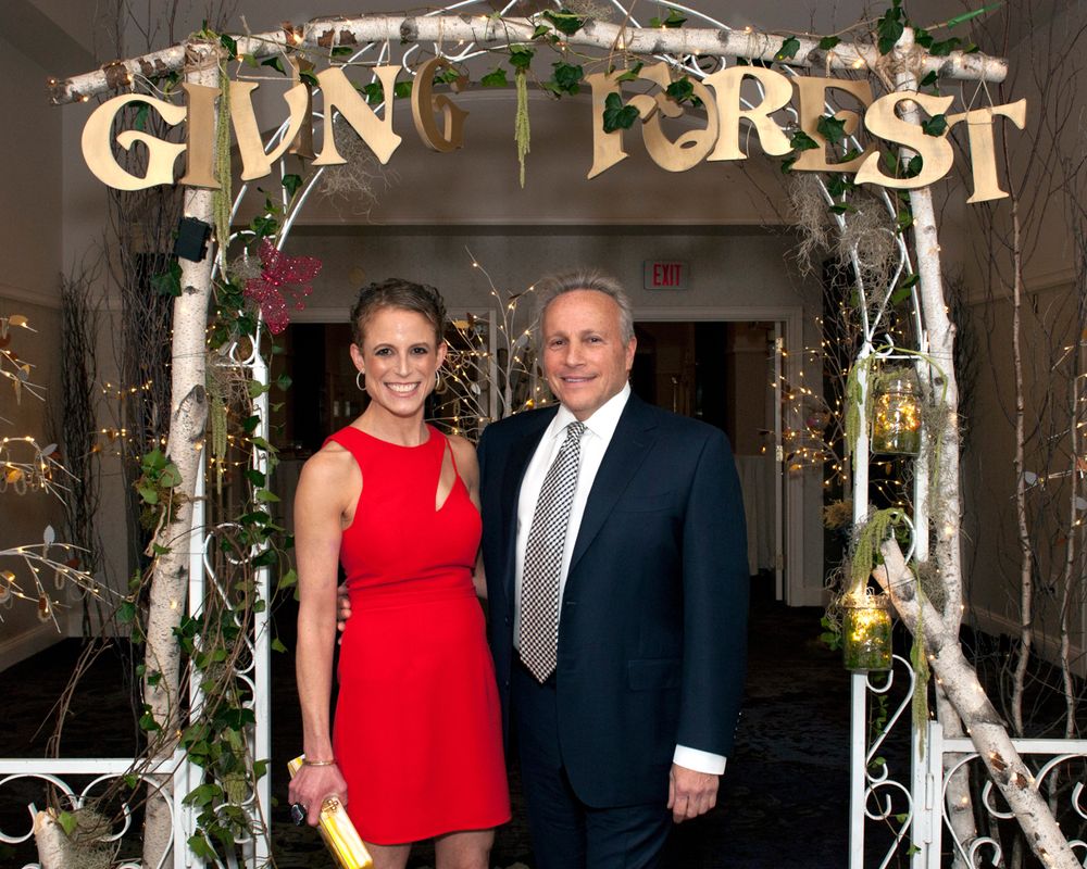 A decorated archway entrance labeled 'Gun Forest' with lights and greenery.