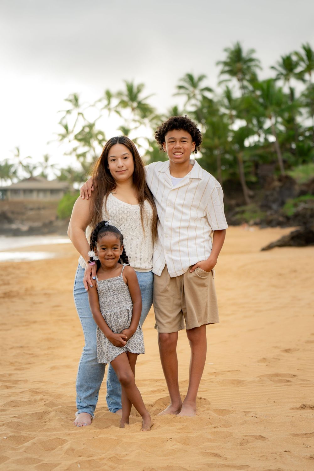 Casual family photos on a sandy beach with palm trees in the background.
