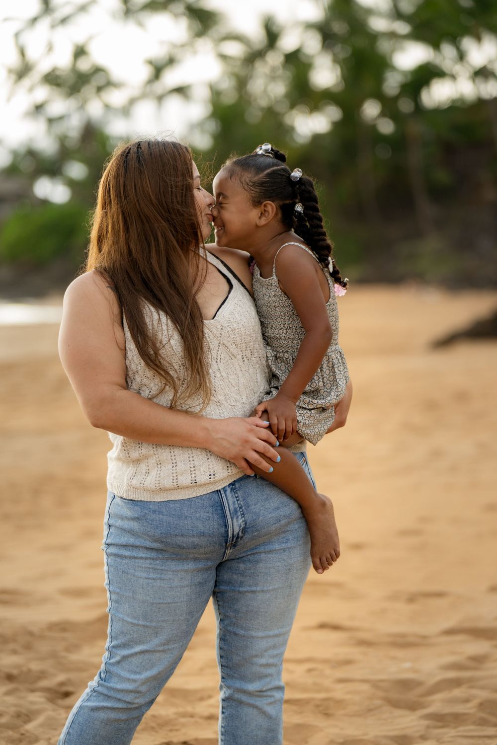 Tender embraces and loving moments shared on a sandy beach at sunset.