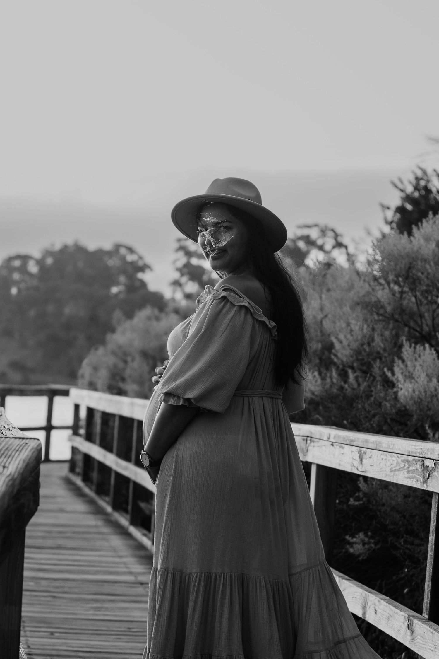 Pregnant woman standing on a bridge
