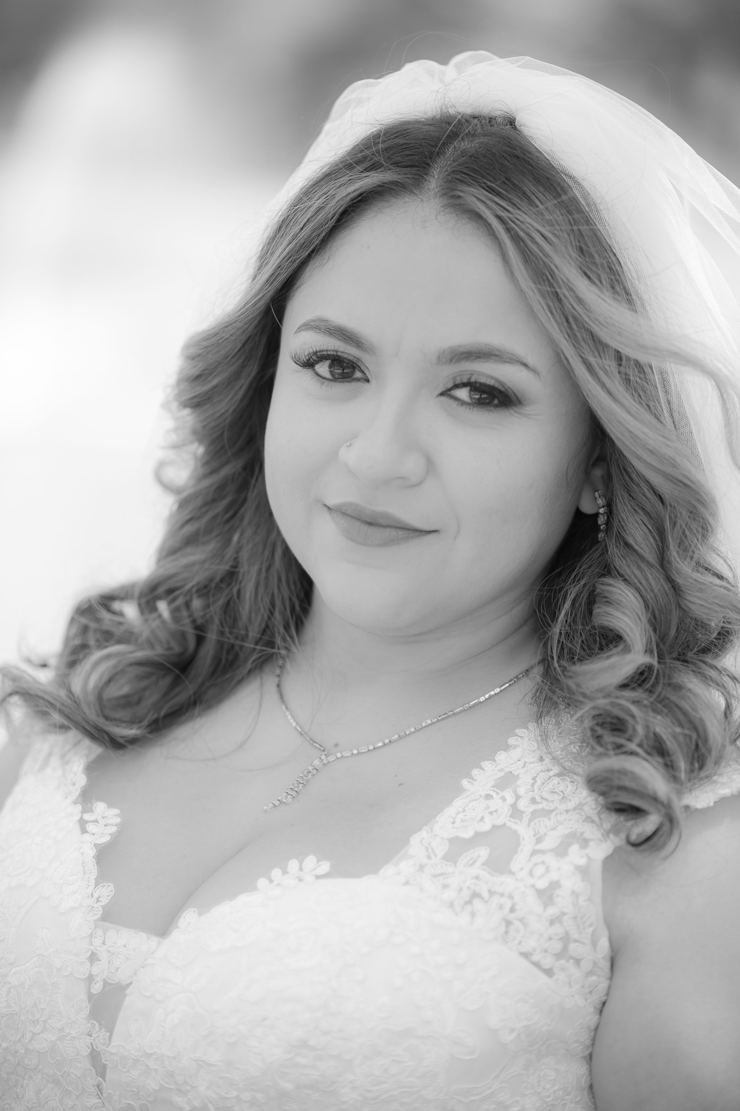 Close-up bridal portrait featuring delicate lace details and soft romantic styling.