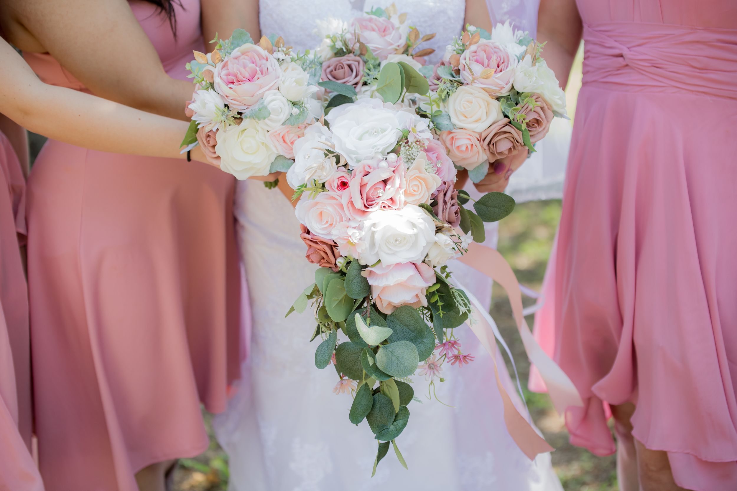 Pink bridesmaid dresses and white floral bouquets displayed in detail shots.