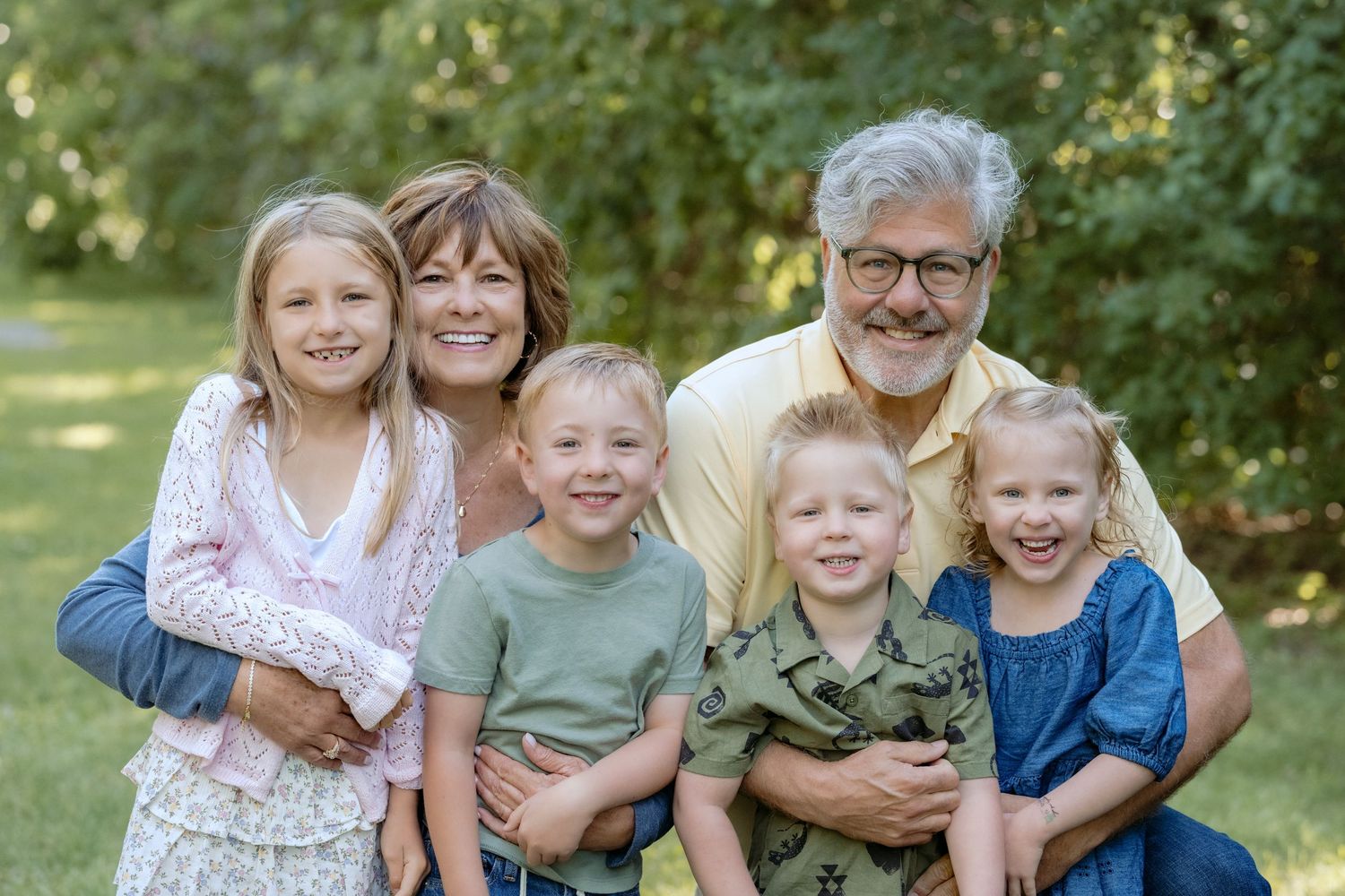 portrait of grandparents with all grandchildren during extended family portrait session at powers lake park in woodbury mn