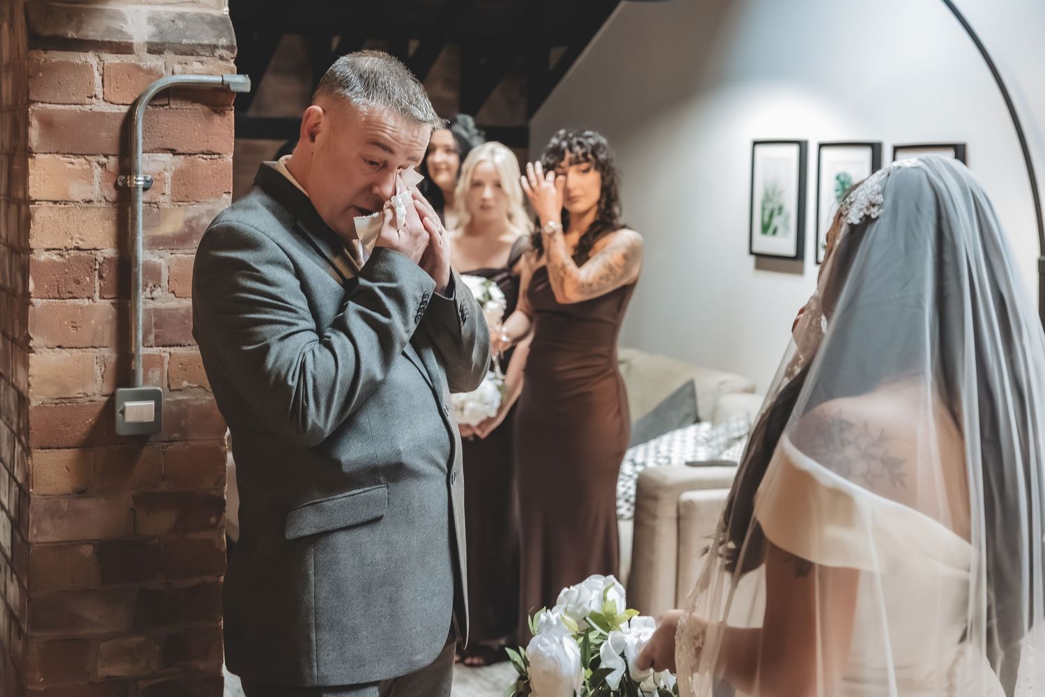 Emotional wedding moment between bride and father.