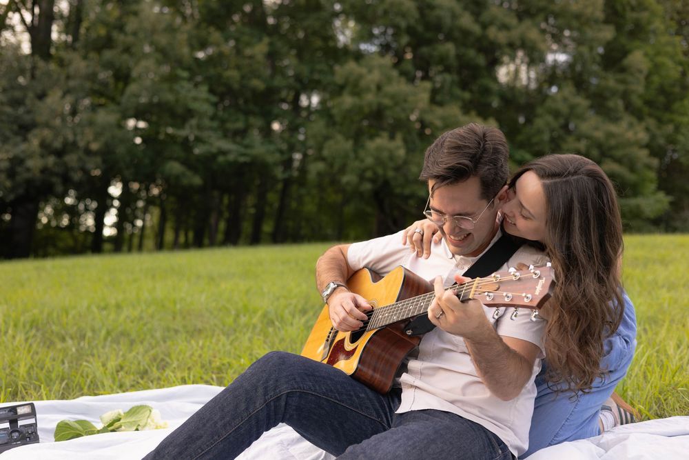 Golden Hour Couples Session at Walnut Creek Park on a blanket with a guitar.