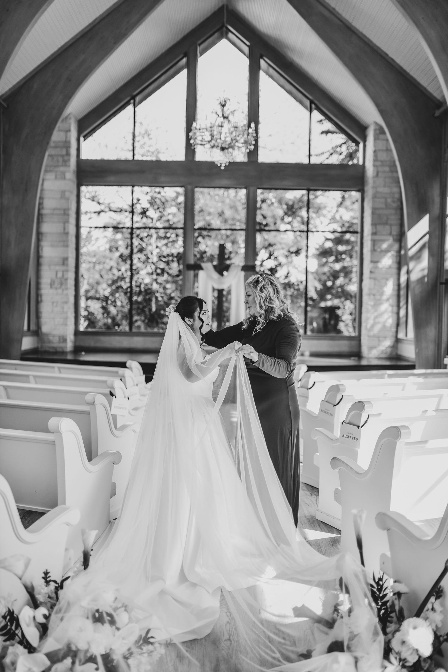 Mother placing bridal veil on her daughter before the ceremony