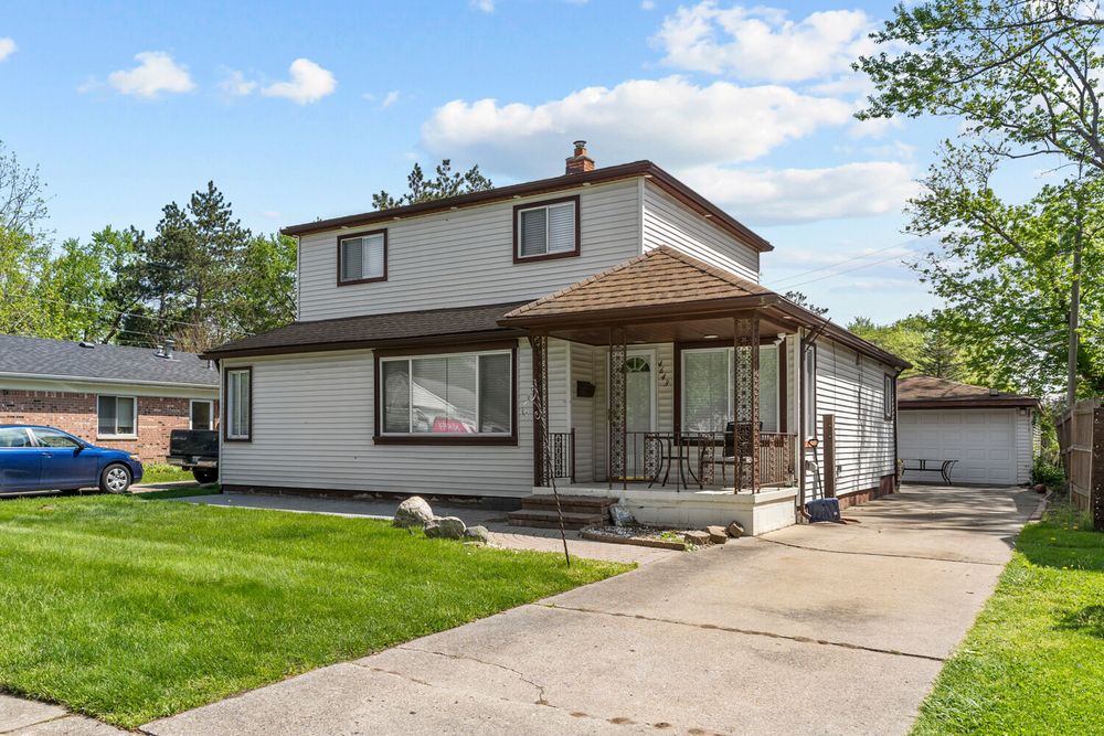 Front exterior of two story home with covered porch on Academy Street Dearborn Michigan