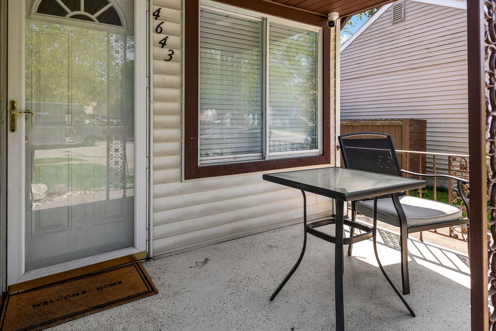 Front exterior of two story home with covered porch on Academy Street Dearborn Michigan