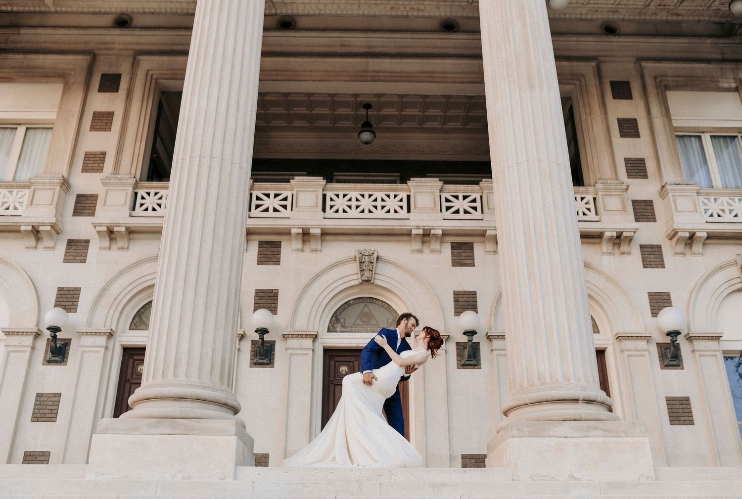 Couple dipping during romantic Downtown Dallas engagement session