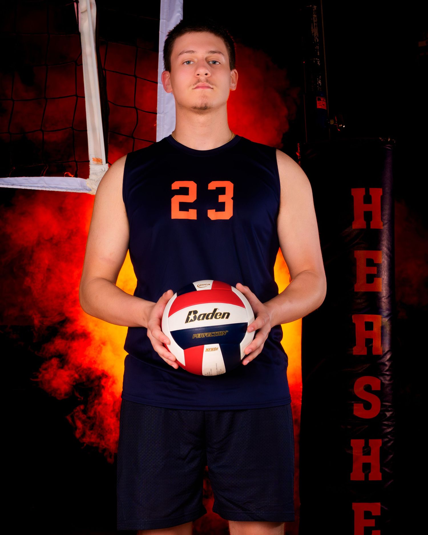 Hershey Trojans boys volleyball player Media Day portrait with dramatic orange lighting, by Deanna Fox, SportsFox Photography, Hershey PA